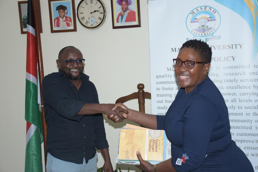 Maseno University’s Director of Linkages and Collaborations, Prof. Rose Ongati (Right) receives books donated by British Institute of Africa from Dr. Kennedy Gatu.